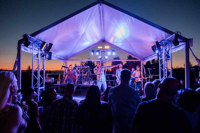 Country singer performing at sunset at a private estate in Oregon